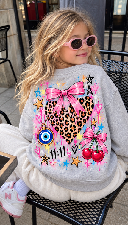 Back of the Peace, Love & Leopard kids' sweatshirt in grey marl with a leopard print heart topped with a pink bow, an evil eye, cherries, stars and 11:11 – Miss Runway