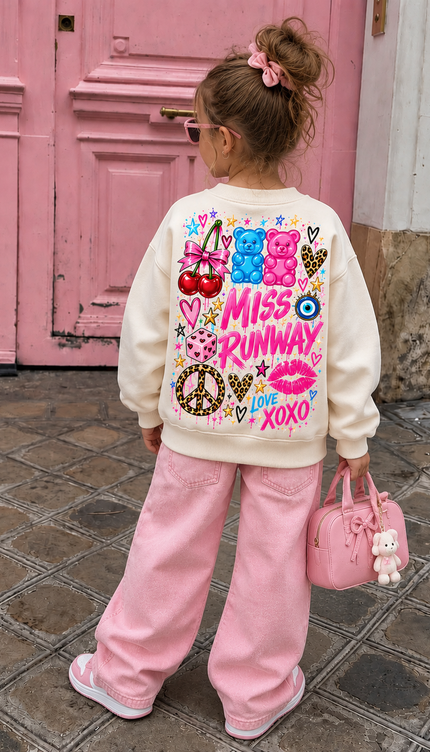 Back of the Gummy Bear Dreams kids' sweatshirt in cream with pink and blue gummy bears above MISS RUNWAY lettering, with cherries, a peace sign, lips, an evil eye and Love XOXO – Miss Runway
