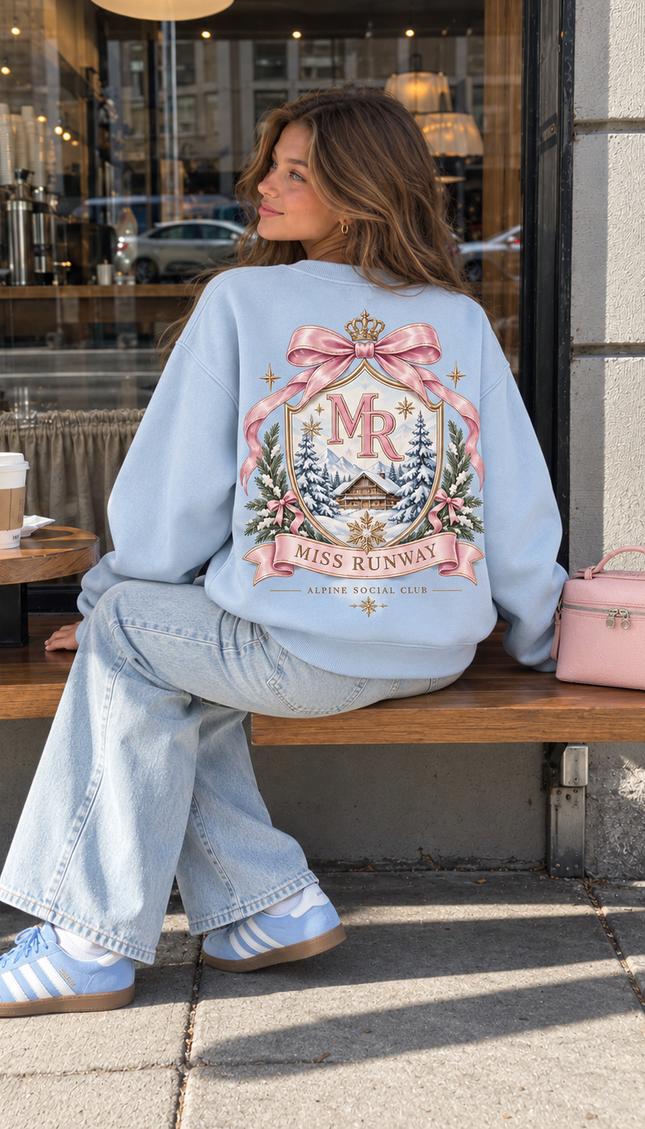 Back of the Alpine Social Club kids' sweatshirt in baby blue with a pastel MR crest, crown and pink bow