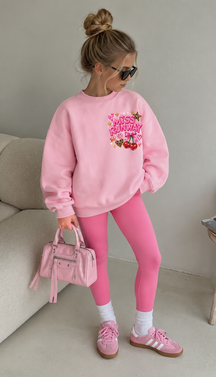 Front of the Girls Worldwide kids' sweatshirt in pink with pink MISS RUNWAY lettering with cherries on the chest – Miss Runway