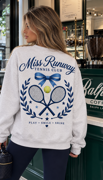 Back of the Miss Runway Tennis Club kids' sweatshirt in grey with a blue bow, crossed rackets and Play Smile Shine motto