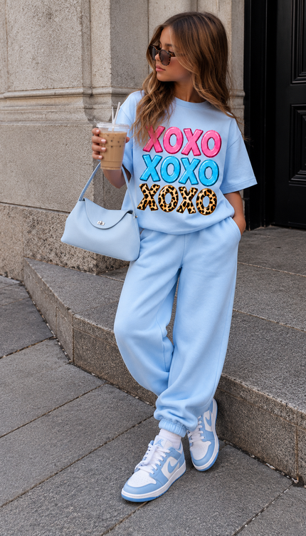 Girl wearing the Blue Kids Joggers with a blue XOXO printed T-shirt by Miss Runway