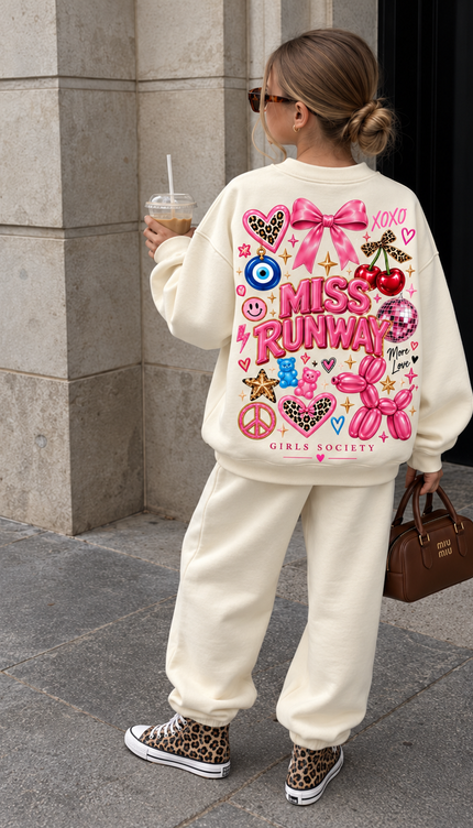 Back of the Pink Pop Icon kids' sweatshirt in cream with pink MISS RUNWAY lettering with a bow, cherries, an evil eye, a gummy bear, a balloon dog, a disco ball and Girls Society script – Miss Runway