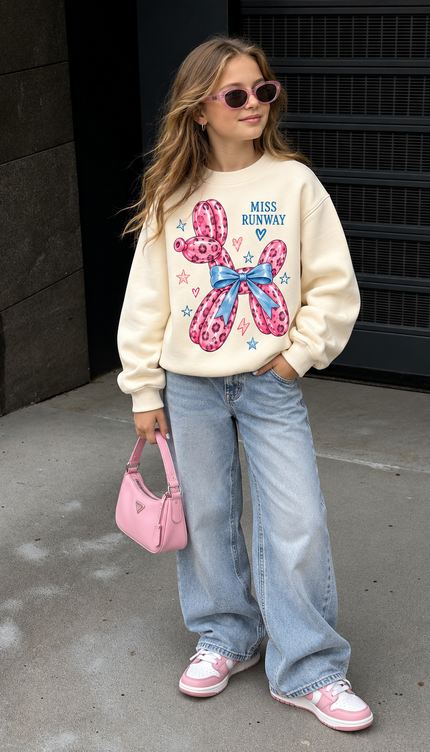 Girl wearing the Pink Leopard Balloon Sweatshirt in cream with a pink leopard balloon dog print by Miss Runway