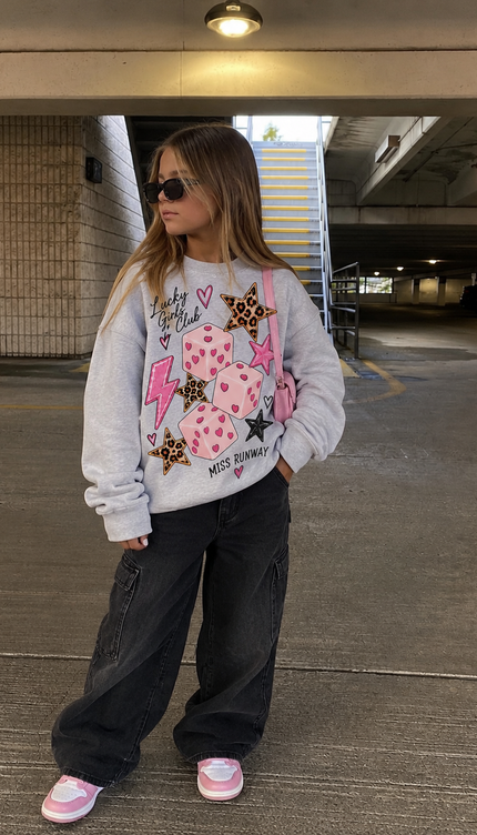 Girl wearing the Pink Dice Sweatshirt in grey with a pink and leopard dice print by Miss Runway