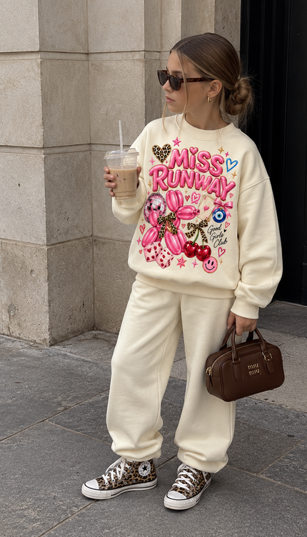 Front of the Pink Pop Icon kids' sweatshirt in cream with pink bubble MISS RUNWAY lettering with a pink balloon dog, cherries, a smiley, an evil eye and a leopard heart – Miss Runway