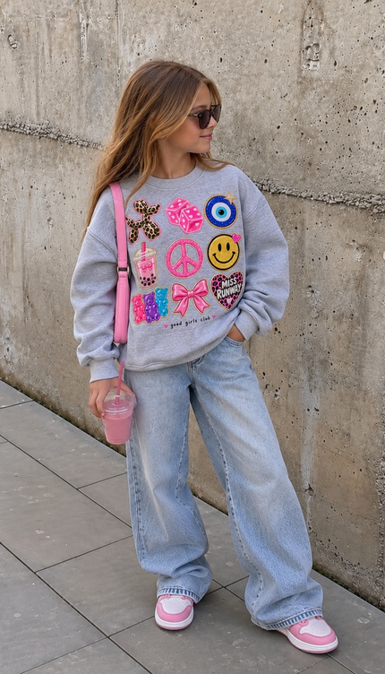 Girl wearing the Lucky Charms Sweatshirt in grey with a lucky charm patches print by Miss Runway