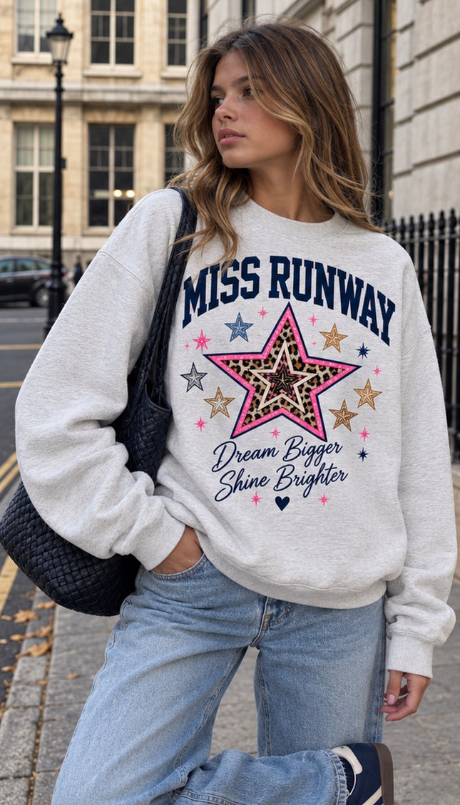 Front of the Dream Bigger Star kids' sweatshirt in grey with a pink and leopard print star and Dream Bigger Shine Brighter slogan