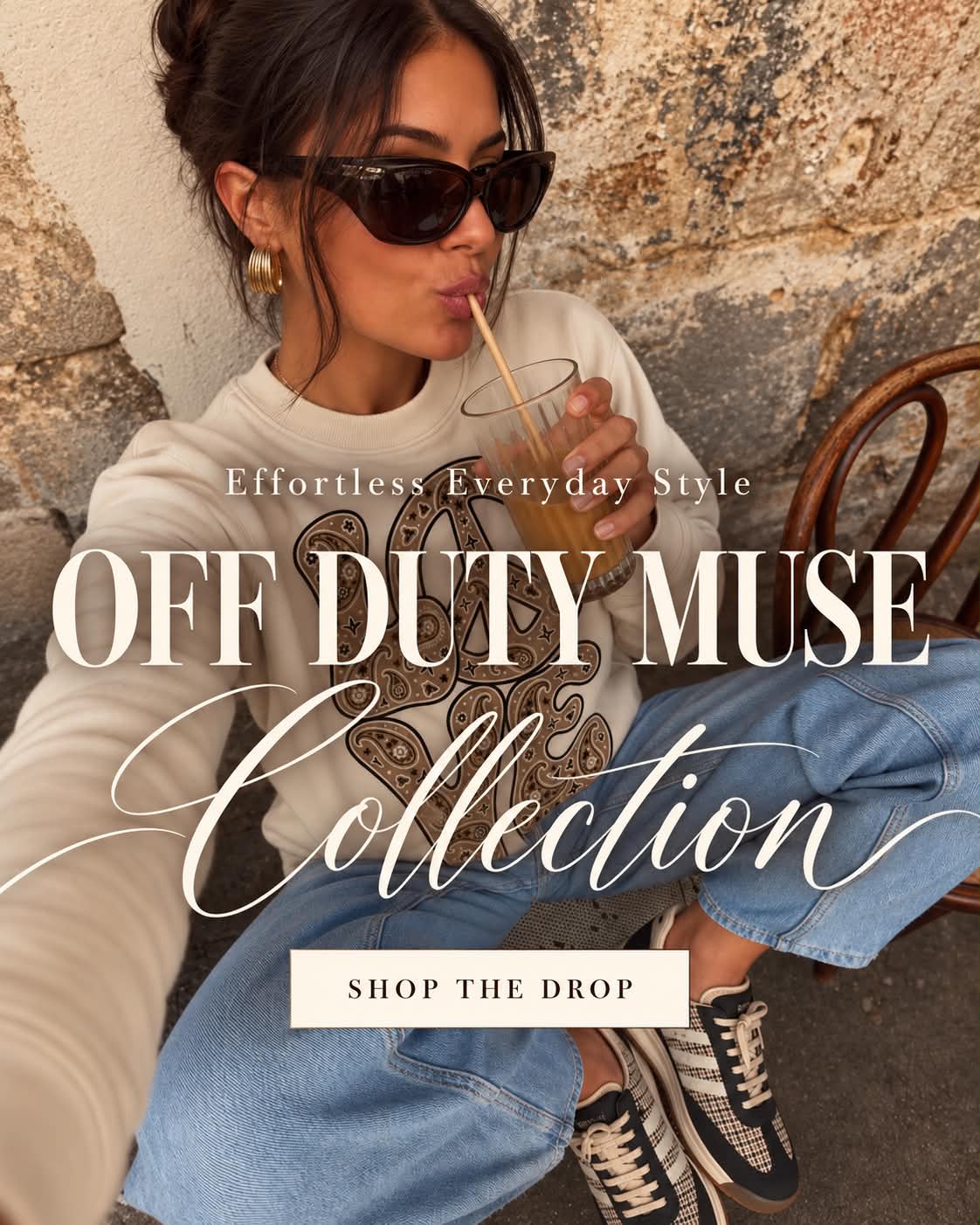 Effortless everyday style: Off Duty Muse Collection. Model in a cream graphic sweatshirt and wide-leg jeans. Shop the drop.